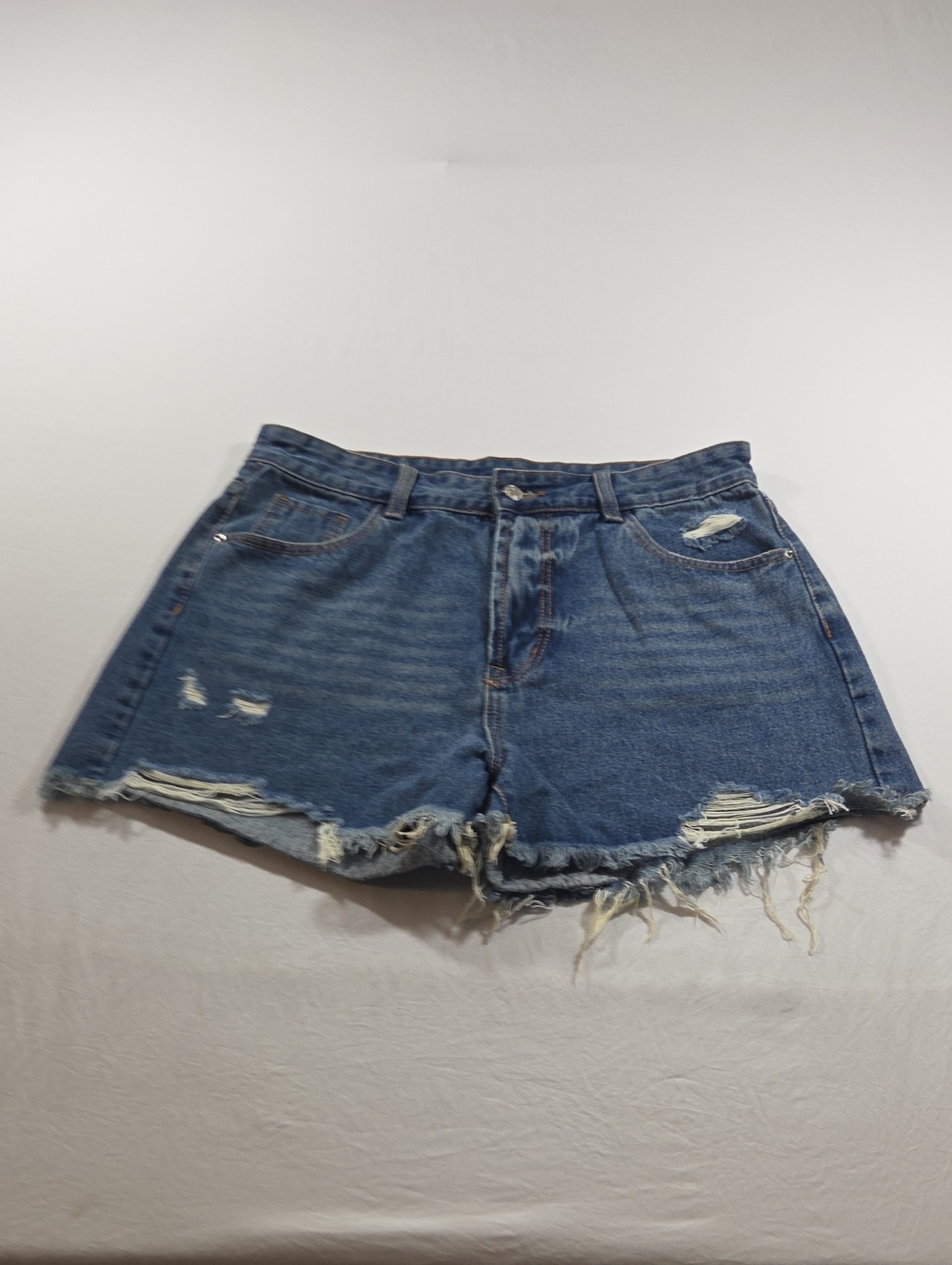 High-Rise Distressed Denim Shorts in Blue